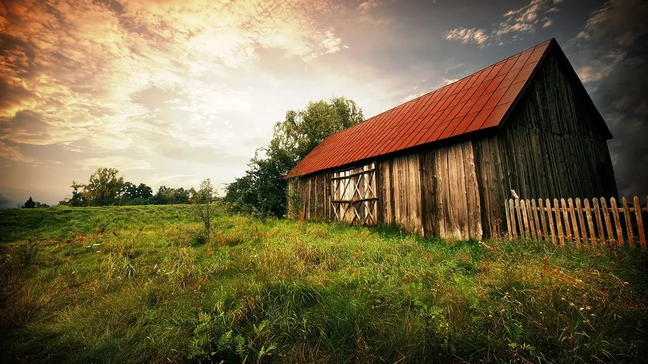 An old country barn at sunset.